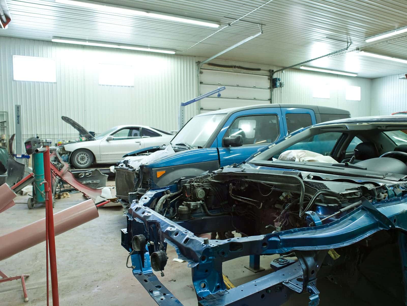 Vehicles inside automotive body shop