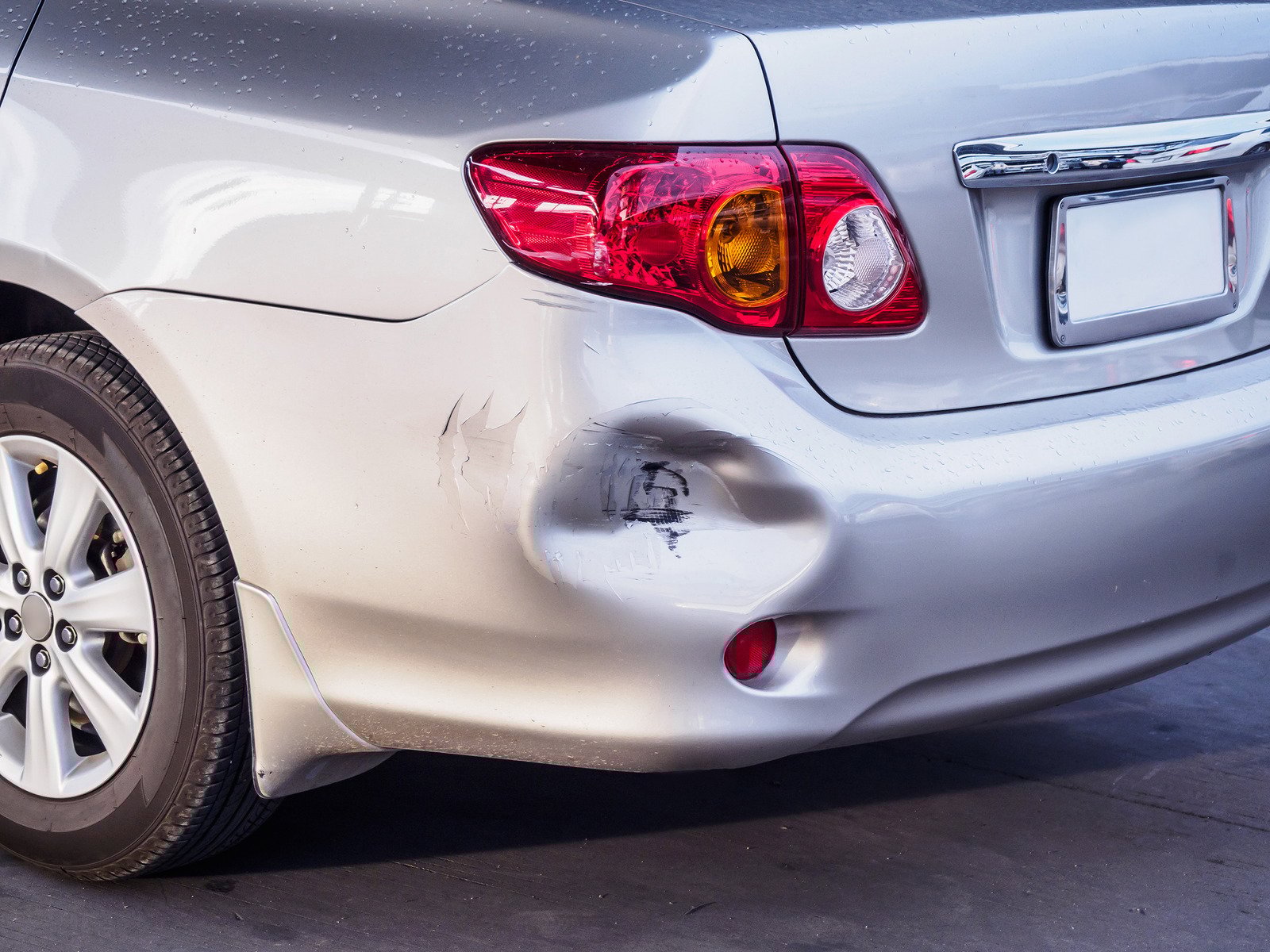 car has dented rear bumper damaged after accident