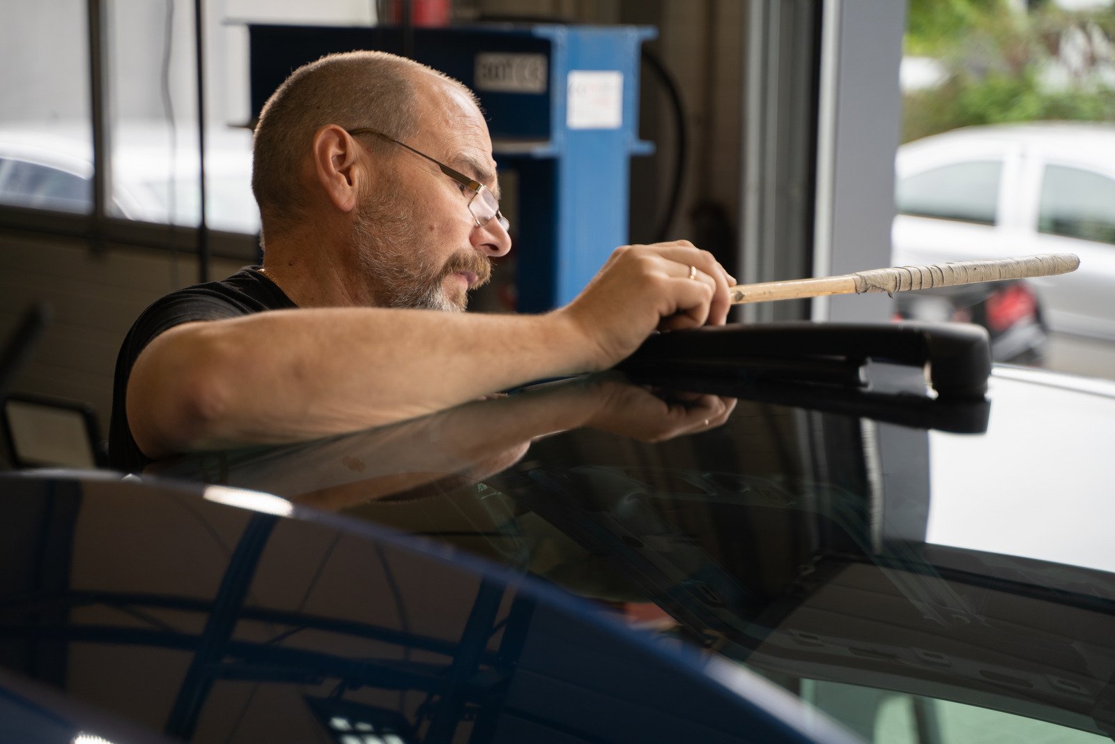 Professional Paintless Dent Repair Technician Is Repairing Dents On Car Body